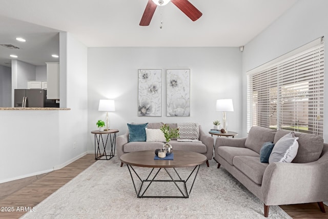 living room featuring hardwood / wood-style flooring and ceiling fan