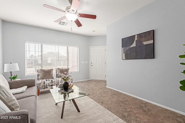 living room featuring light tile patterned floors and ceiling fan