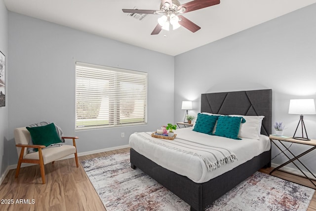 bedroom with wood-type flooring and ceiling fan