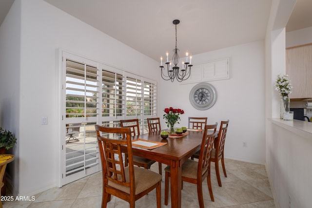 dining space with light tile patterned floors, baseboards, and a notable chandelier