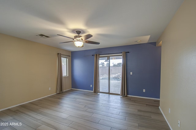 spare room featuring ceiling fan and light hardwood / wood-style flooring