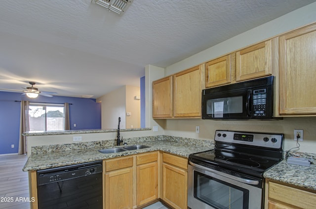 kitchen with light brown cabinetry, sink, kitchen peninsula, and black appliances