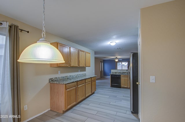 kitchen featuring ceiling fan, black dishwasher, stainless steel refrigerator, pendant lighting, and light hardwood / wood-style flooring