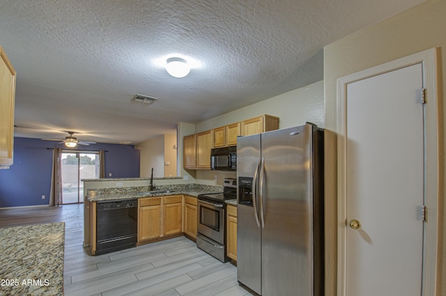 kitchen featuring ceiling fan, black appliances, sink, light wood-type flooring, and light stone countertops