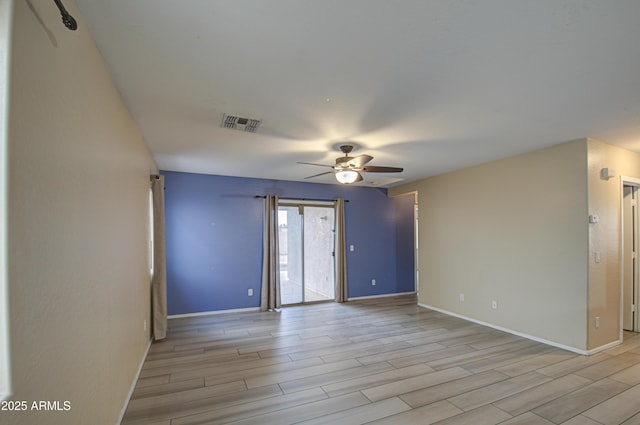 spare room featuring ceiling fan and light hardwood / wood-style flooring