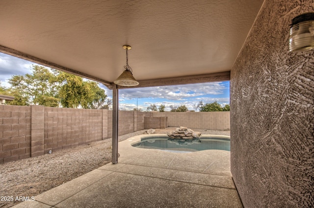 view of patio / terrace with a fenced in pool