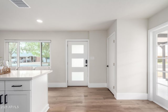 foyer featuring recessed lighting, visible vents, light wood-style flooring, and baseboards