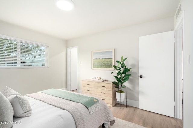 bedroom featuring light wood-type flooring and visible vents