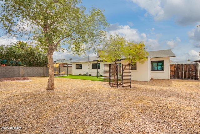 back of property with a fenced backyard