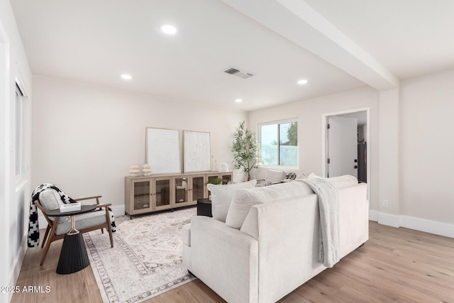 living room with visible vents, recessed lighting, light wood-type flooring, and baseboards