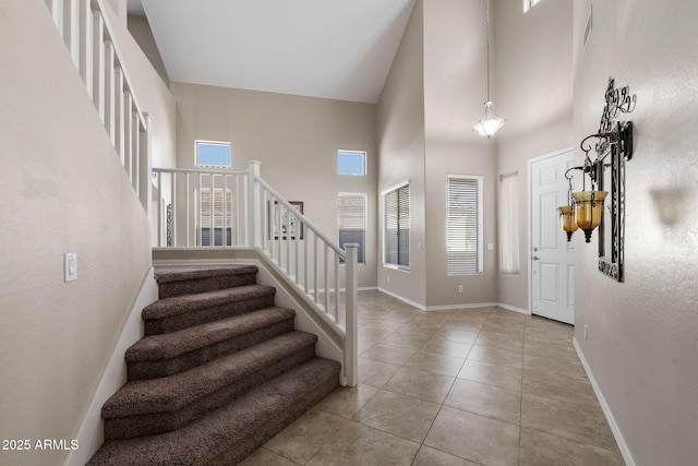 2036 E Carob Dr, Chandler, AZ 85286 - tiled entrance foyer featuring a high ceiling, stairs, and baseboards