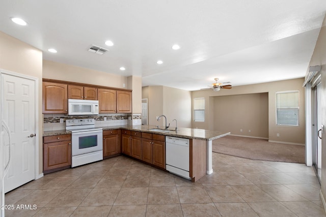 2036 E Carob Dr, Chandler, AZ 85286 - kitchen with white appliances, a sink, light carpet, a peninsula, and a ceiling fan