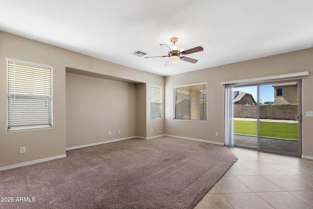 2036 E Carob Dr, Chandler, AZ 85286 - empty room with a ceiling fan, baseboards, light tile patterned floors, and light carpet