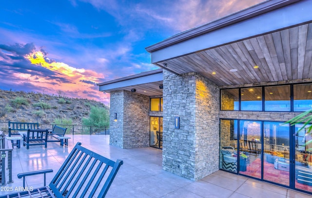 view of patio terrace at dusk