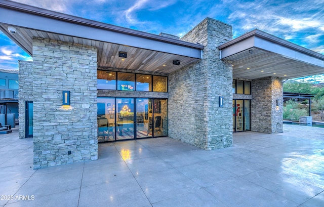 doorway to property with stone siding