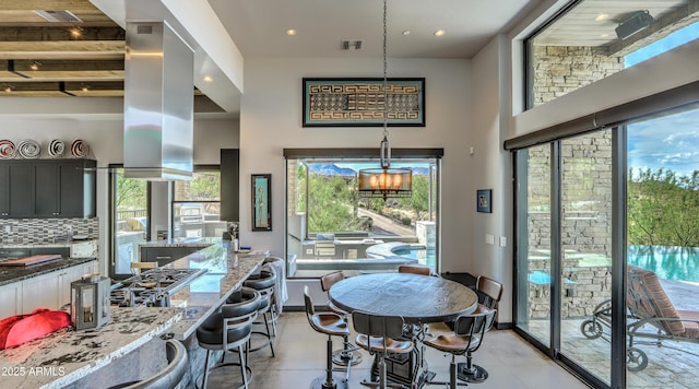 dining space featuring a high ceiling, visible vents, and recessed lighting