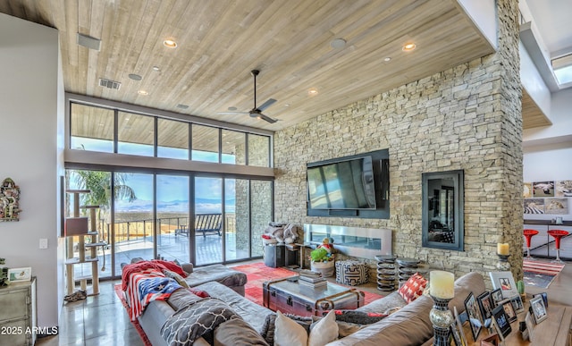 living room featuring recessed lighting, wood ceiling, visible vents, and a high ceiling