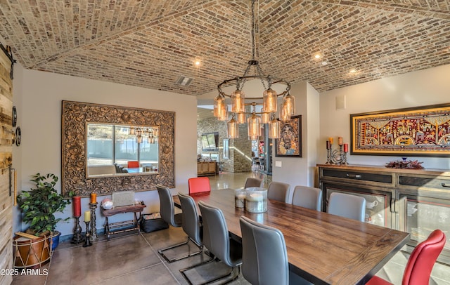 dining area featuring brick ceiling, concrete floors, and visible vents