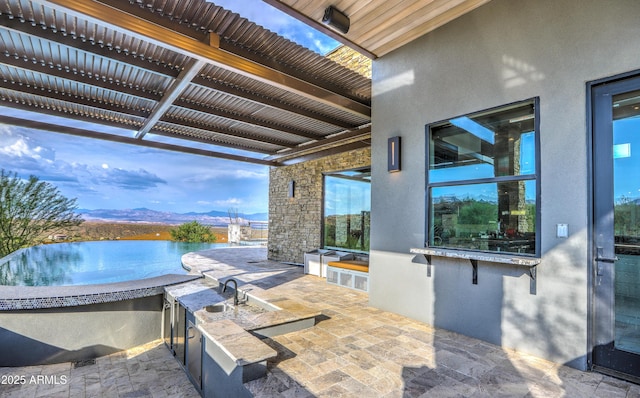 view of patio / terrace with a water and mountain view, area for grilling, and a pergola