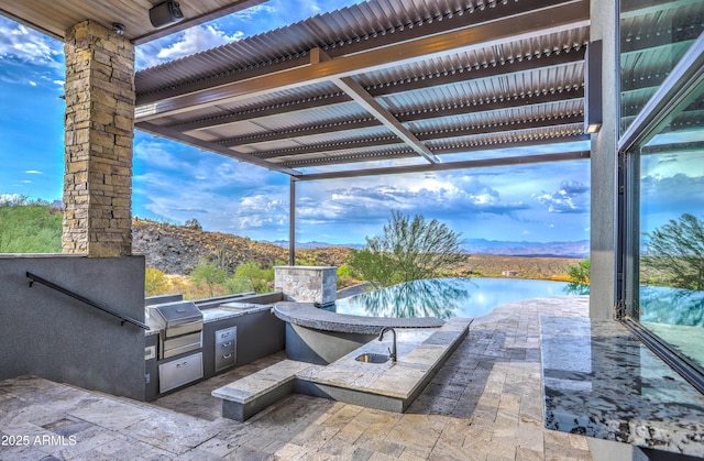 view of patio with grilling area, area for grilling, and a pergola