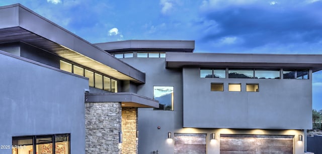 exterior space with stone siding and stucco siding