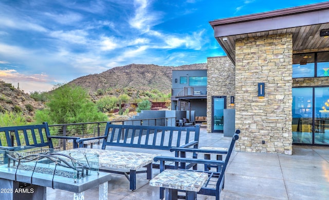 view of patio with a mountain view and an outdoor hangout area