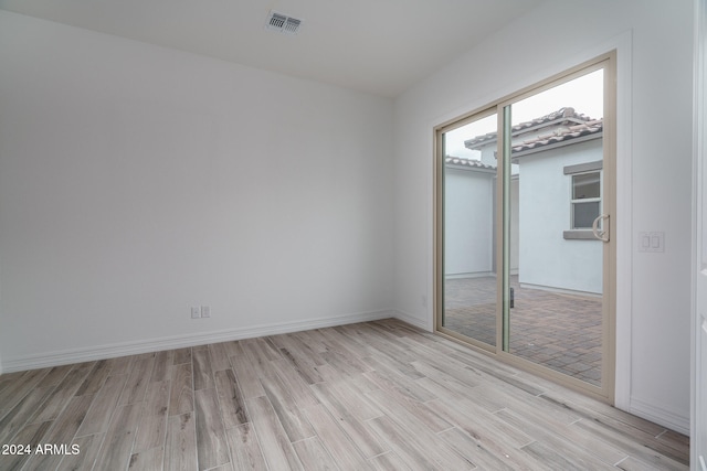 unfurnished bedroom with a closet and light hardwood / wood-style flooring