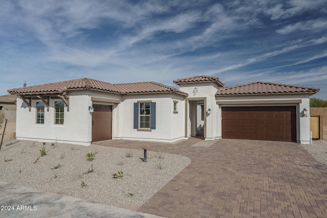 mediterranean / spanish-style home featuring a garage