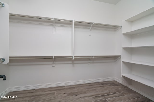 walk in closet featuring dark hardwood / wood-style flooring