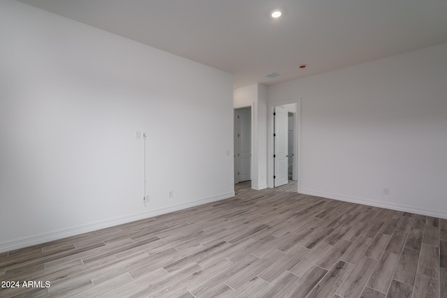 unfurnished room with light hardwood / wood-style flooring