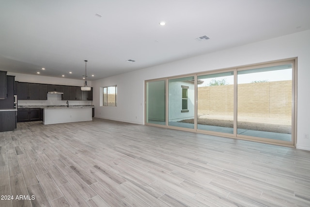 unfurnished living room with light wood-type flooring