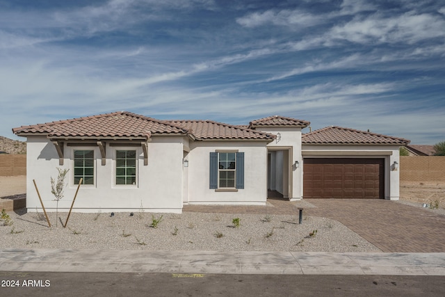 mediterranean / spanish house featuring a garage