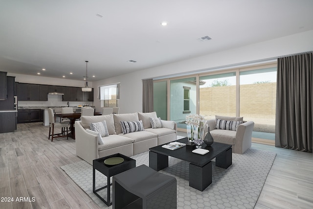 living room featuring light hardwood / wood-style floors and a wealth of natural light