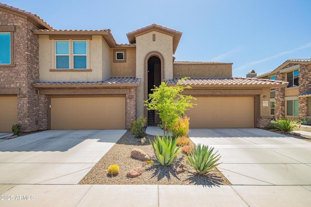 2425 W Bronco Butte Trl Unit 2028, Phoenix, AZ 85085 - view of front of house with driveway, stucco siding, a tile roof, and stone siding