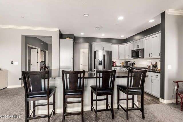 2425 W Bronco Butte Trl Unit 2028, Phoenix, AZ 85085 - kitchen with high end refrigerator, dark countertops, a kitchen bar, backsplash, and white cabinets