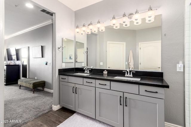 2425 W Bronco Butte Trl Unit 2028, Phoenix, AZ 85085 - full bathroom featuring double vanity, wood finished floors, baseboards, and crown molding