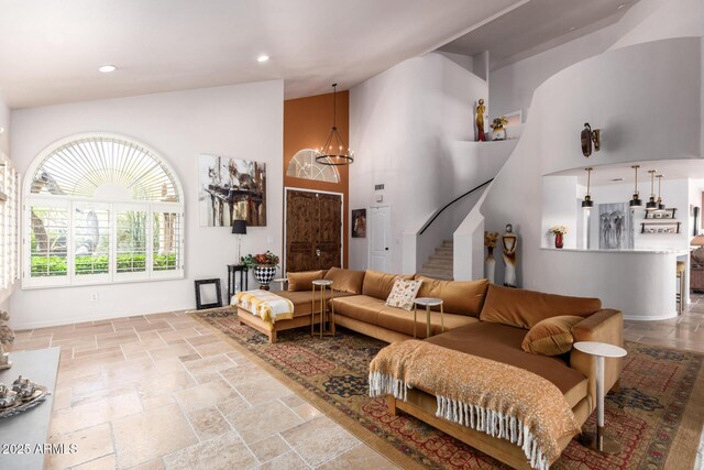 living room with stone tile floors, high vaulted ceiling, stairway, a chandelier, and recessed lighting