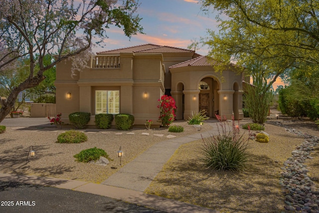 mediterranean / spanish-style home with stucco siding and a tiled roof