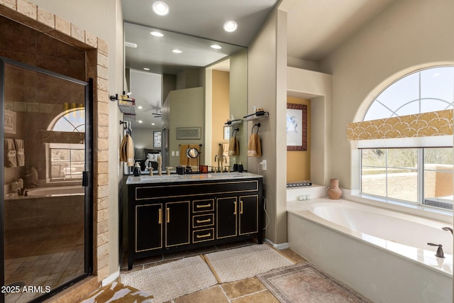full bathroom featuring a garden tub, vanity, a stall shower, and recessed lighting