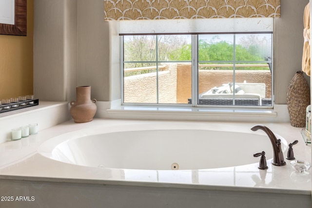 bathroom with plenty of natural light and a jetted tub