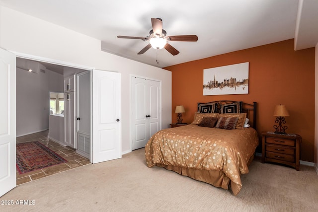 bedroom with carpet floors, a ceiling fan, a closet, and baseboards