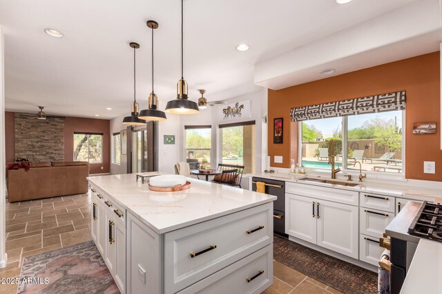 kitchen featuring a kitchen island, plenty of natural light, white cabinetry, open floor plan, and recessed lighting