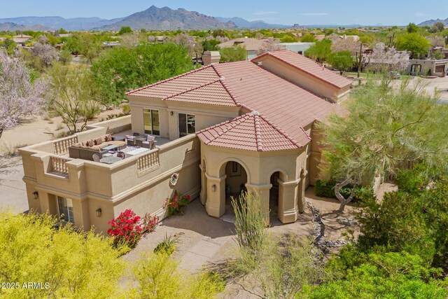 view of front of property featuring a tiled roof, stucco siding, and a mountain view