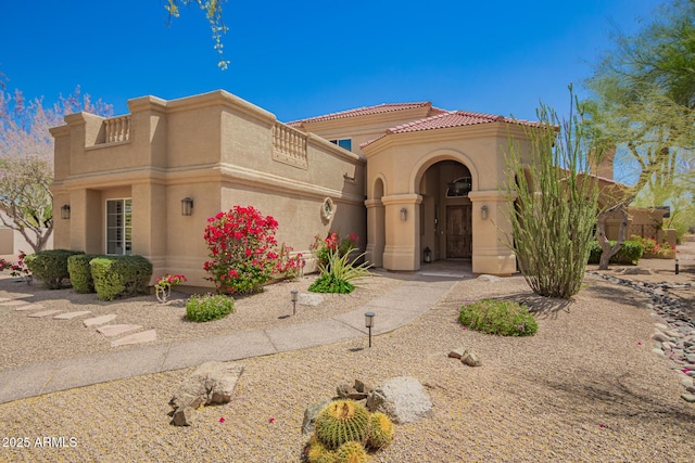 view of front of house with stucco siding and a tiled roof