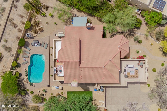 aerial view of property and surrounding area featuring a pool
