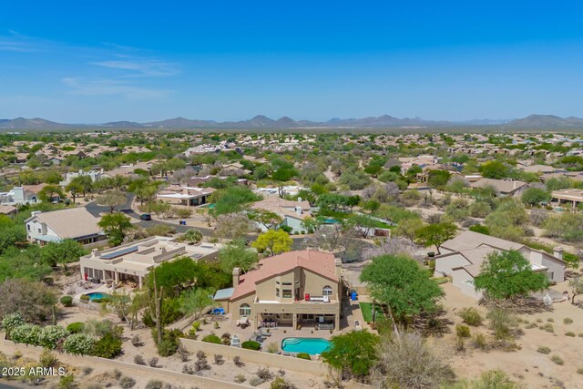 aerial overview of property's location featuring mountains, a pool area, and nearby suburban area