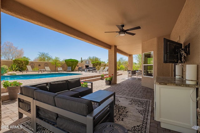 view of patio / terrace featuring an outdoor hangout area, a ceiling fan, and fence