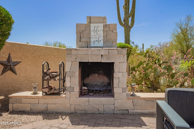view of patio with an outdoor stone fireplace
