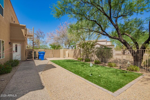 view of yard with stairs and fence