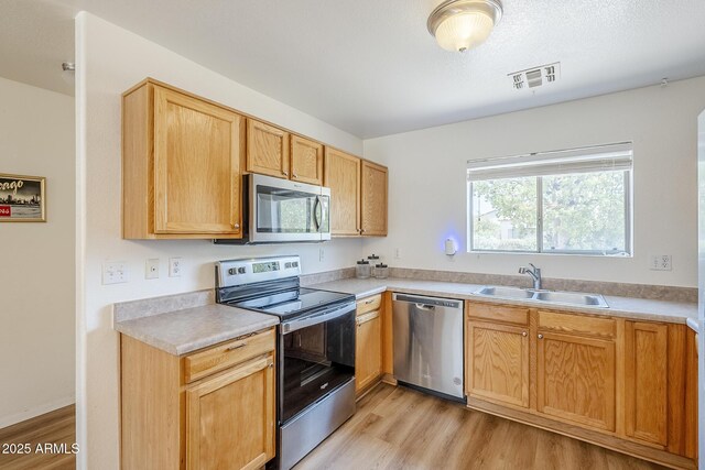 941 E Desert Moon Trl, San Tan Valley, AZ 85143 - kitchen with stainless steel appliances, light wood-style floors, and light countertops